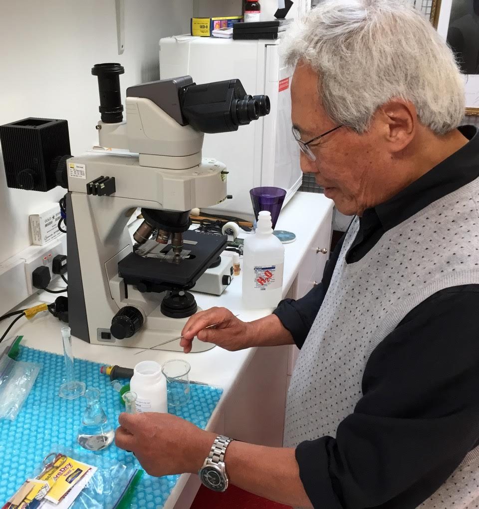 Dr. Sungchul Ji at the microscope